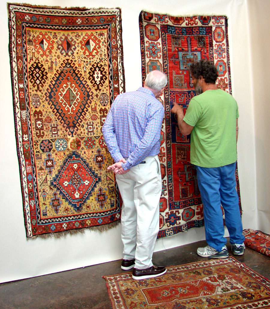 Jeff Dworsky, Stonington, Maine, discusses a Nineteenth Century East Anatolian Kurdish rug with a client.