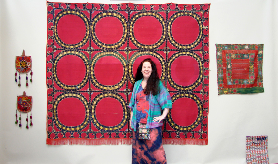 Raven Ziegler, a Stamford Conn., collector, is shown with a Tashkent Suzani, circa 1860, in the booth of Casey Waller, Dallas. Comprising several panels, these textiles were often made to be part of a bride’s dowry.