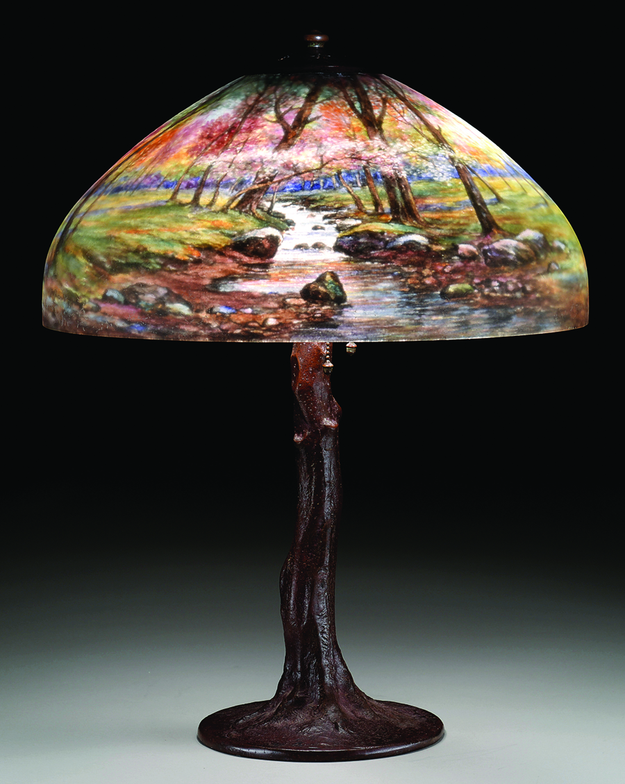 Leading the Handel lamps was a table lamp with a reverse painted shade depicting a mountain brook flowing through woods. It achieved $ 35,550. The shade was signed “Handel 6826.”