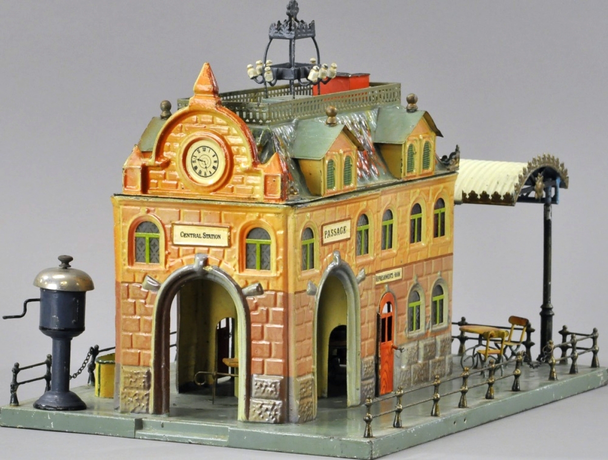 This Marklin Central Station, Germany, is very well detailed, hand enameled with interior table, chairs and benches, with etched and stained glass windows and arches on side, ticket window and outdoor seating and café. It is 16½ inches wide, excellent condition, and sold for $32,450, well over the $20,000 high estimate.