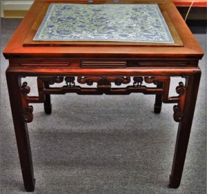 With a 25½-inch-square inset porcelain plaque, this Chinese rosewood table sold for $22,230. The porcelain was dated as Eighteenth or Nineteenth Century and the table itself was later.