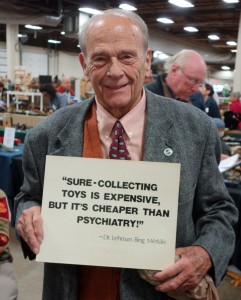 David Bausch, manager of the toy show, with his “Practice What You Preach”’ sign.