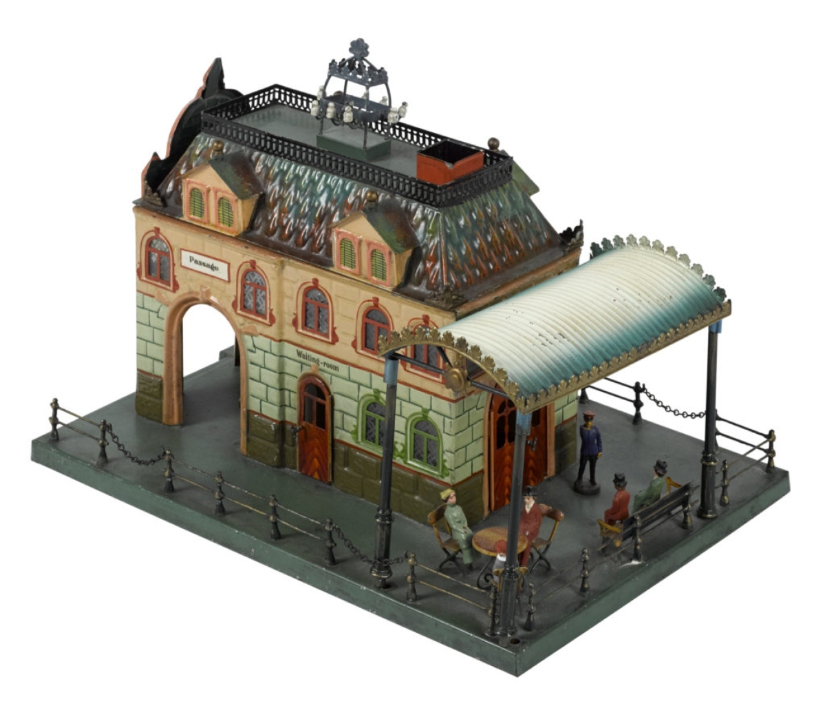Selling at the high estimate, $18,000, was this Marklin Central-Bahnhof Train Station, no. 2651, hand painted with candlelit interior with tables, chairs and benches. It has etched and stained glass windows and features an outdoor café under an arched canopy. It was last sold on May 21, 2011, at a Noel Barrett auction.
