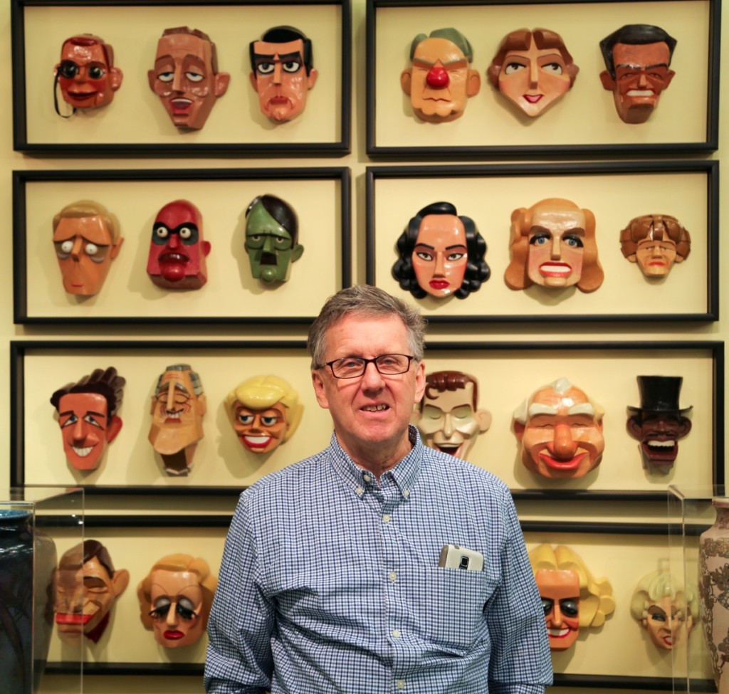 Paul Thien, Firehouse Antiques, Galena, Md., stands with his selection of masks from George Roether.