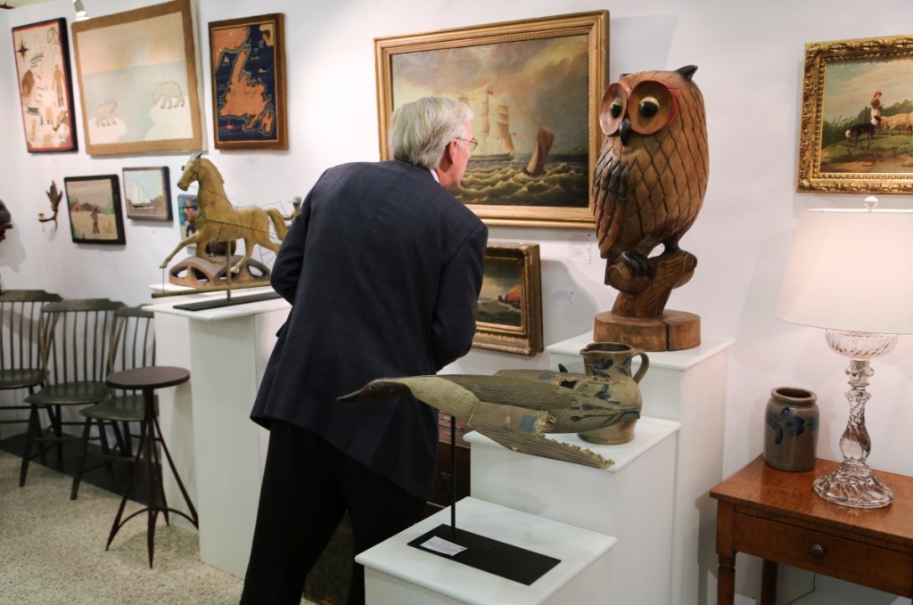 A customer looks at a painting by Reginald Eugene Nickerson titled “The Ship Joshua Sears” at A Bird in Hand, Florham Park, N.J.