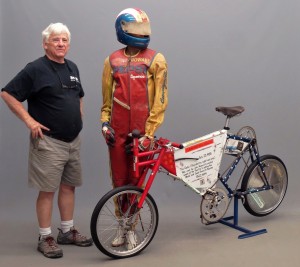 Mike Fallon poses with a land speed record bicycle, ridden by John Howard,and published in the Guinness Book of World Records in 1989 for going152.284 miles per hour on July 20, 1985. The bike will be offered in thisyear’s bicycle auction on April 22.