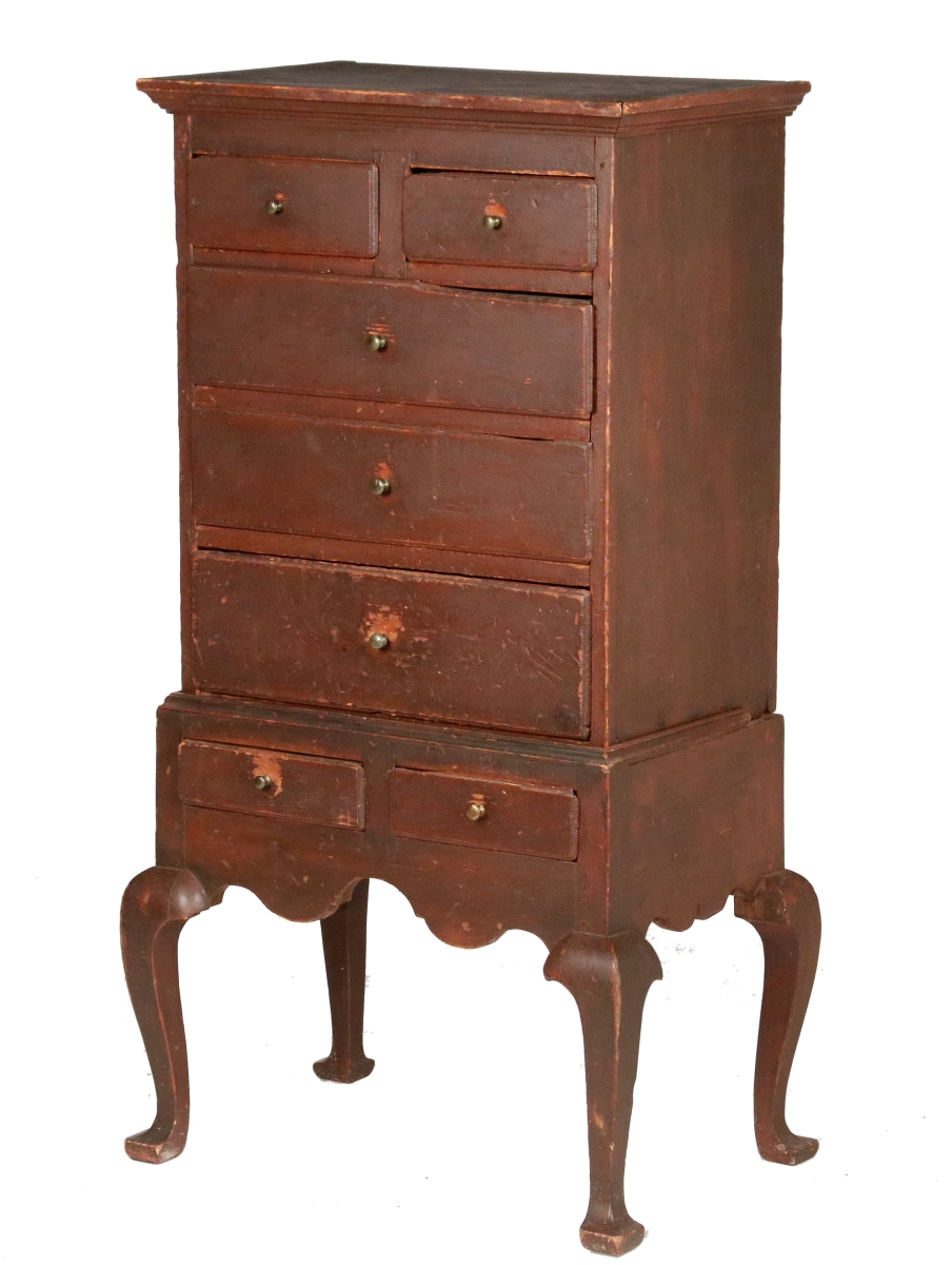Cataloged as originating in the Delaware Valley, this child-size miniature highboy earned $38,610. In old red paint, it was 38 inches tall, had tiny brasses and was dated circa 1750–70.
