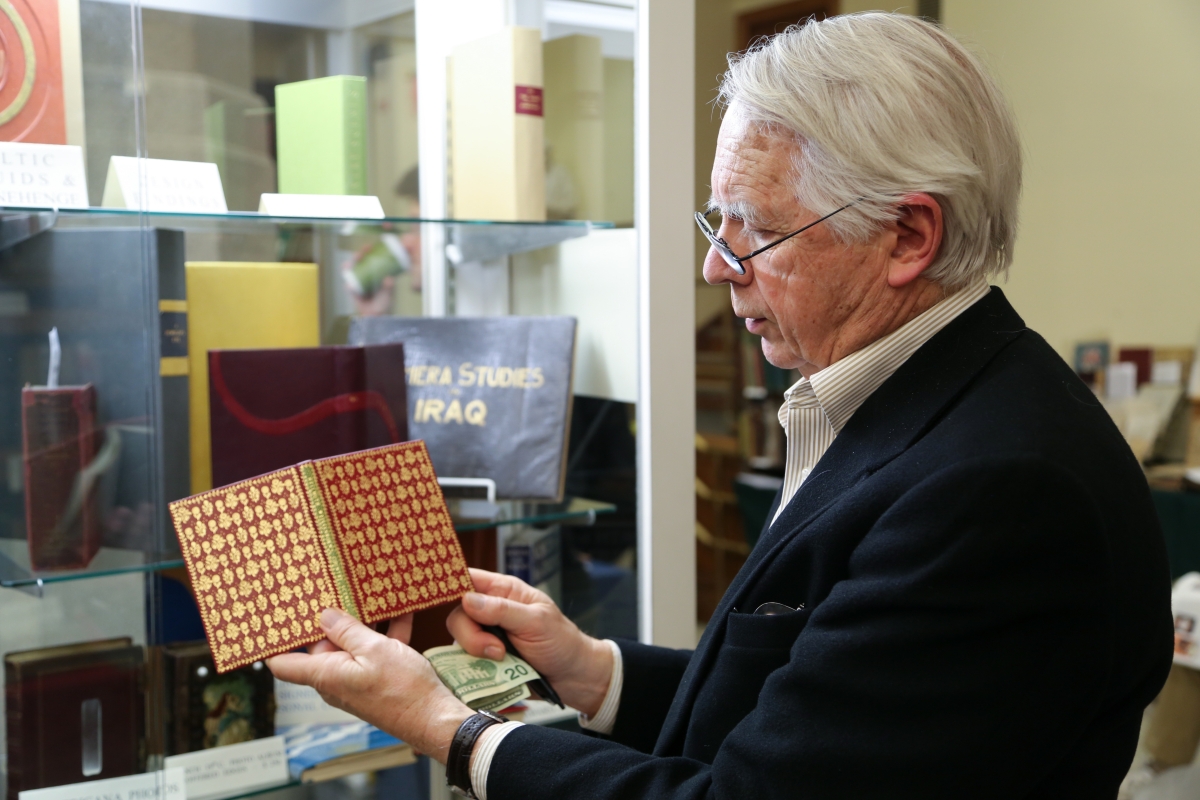 Tom Twetten of Craftsbury Antiquarian Books, Craftsbury Common, Vt., holds up a copy of Hellmuth Weissenborn’s Country Scenes. The book featured a gilt flower design on red backing, applied with a heated brass tool. The binding was done by Christopher Shaw, an English binder.