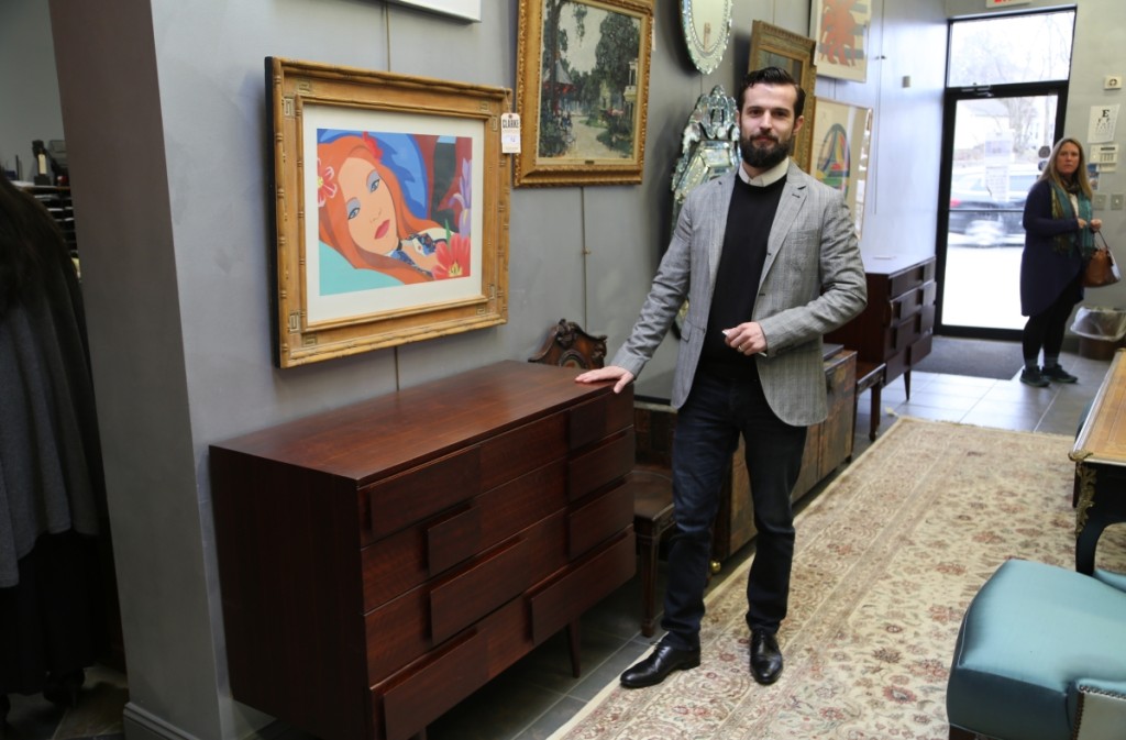 Design specialist Keane Ryan stands with a pair of Gio Ponti chests that produced the top selling lot of the sale at $40,000.