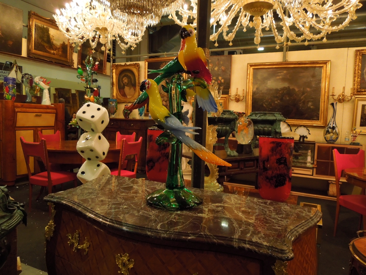 The brightly colored Venetian glass double parrot pedestal on a flared base struck a commanding presence. They were for sale at Capuzzo Andrea, Mesino, Italy.