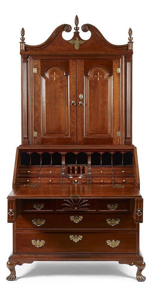 Illustrated in New London County Furniture, this Connecticut Queen Anne desk and bookcase had an unusual inlaid brass eagle under the scrollwork crest and exposed brass hinges. Its provenance included Israel Sack. It sold to Woodbury, Conn., dealers for their personal collection, and they paid $26,400. One of the buyers said he believes the piece was made by Elijah Booth, and was so identified in the book.