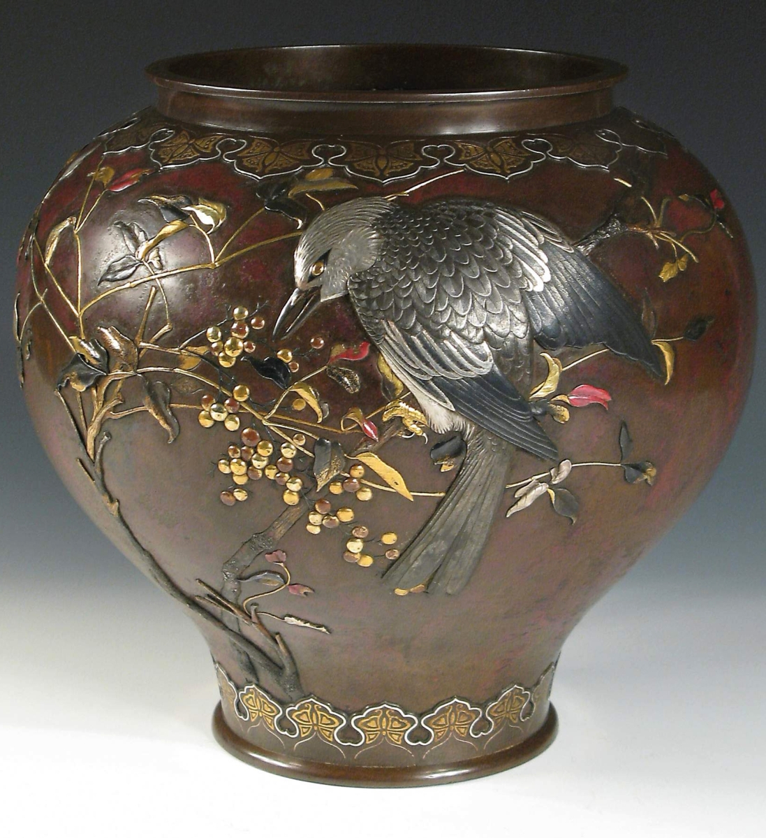 A major Meiji period bronze vase, inlaid and overlaid with precious multimetals and colored enamels, signed by Suzuki Chokichi with his art name, Kako, and having a double mountain mark on base. A similar vase is exhibited in the V&A Museum in London.