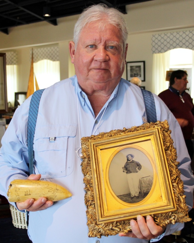 Hyannis Port, Mass., dealer Alan Granby holds the scrimshawed “Map Tooth,” engraved with a chart depicting New Bedford harbor and environs. The piece is published in Flayderman’s Scrimshaw and Scrimshanders. The ambrotype is by New Bedford, Mass., photographer Charles Ebenezer Hawes. It depicts seaman George W. Dodge holding an ebony octant, circa 1856.