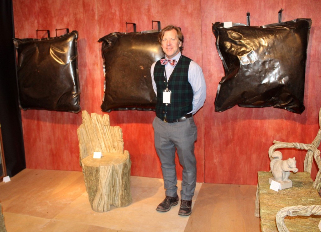 Jeffrey Henkel, Pennington, N.J., with his display of pillow-form sculptures and faux bois garden furniture by Susy Ventura, a vignette that sold completely during the show.