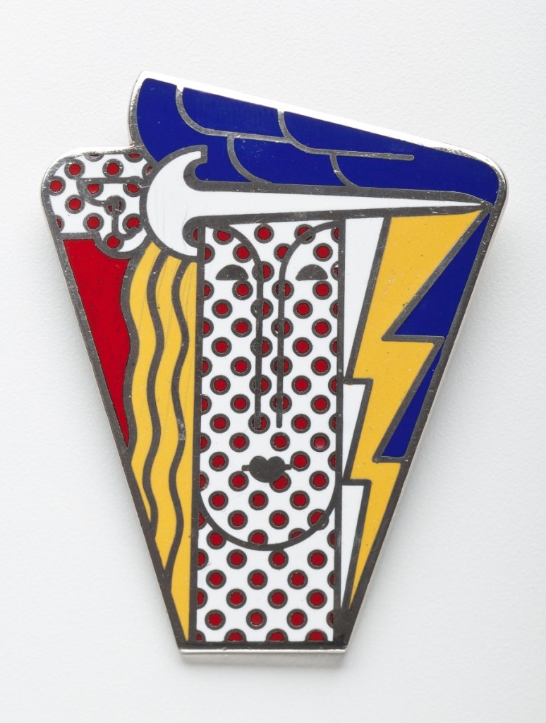 This boldly designed champlevé enamel brooch by Pop artist Roy Lichtenstein was originally produced in 1968 for the Multiples gallery in New York City. It is a pendant and brooch with a pin on the back and a ring for suspension from a chain. The enamel is on a base metal.
