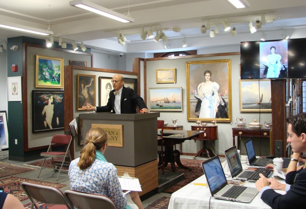 At the podium, Michael Grogan sells the large portrait of Mrs Oliver Gould Jennings, shown on the wall behind him.