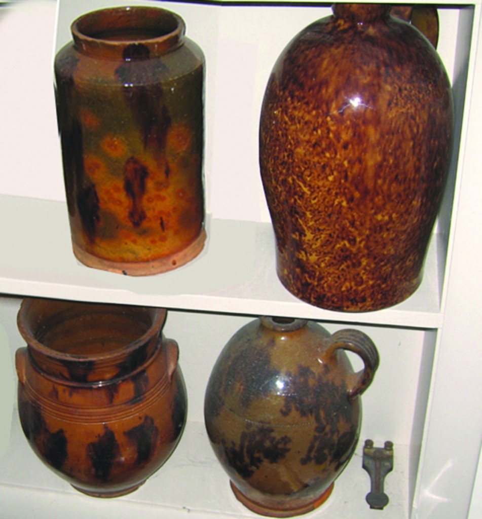 Four of the redware pieces reported stolen, including, at upper right, a speckled-glaze redware jug marked “John Bell” on the shoulder.