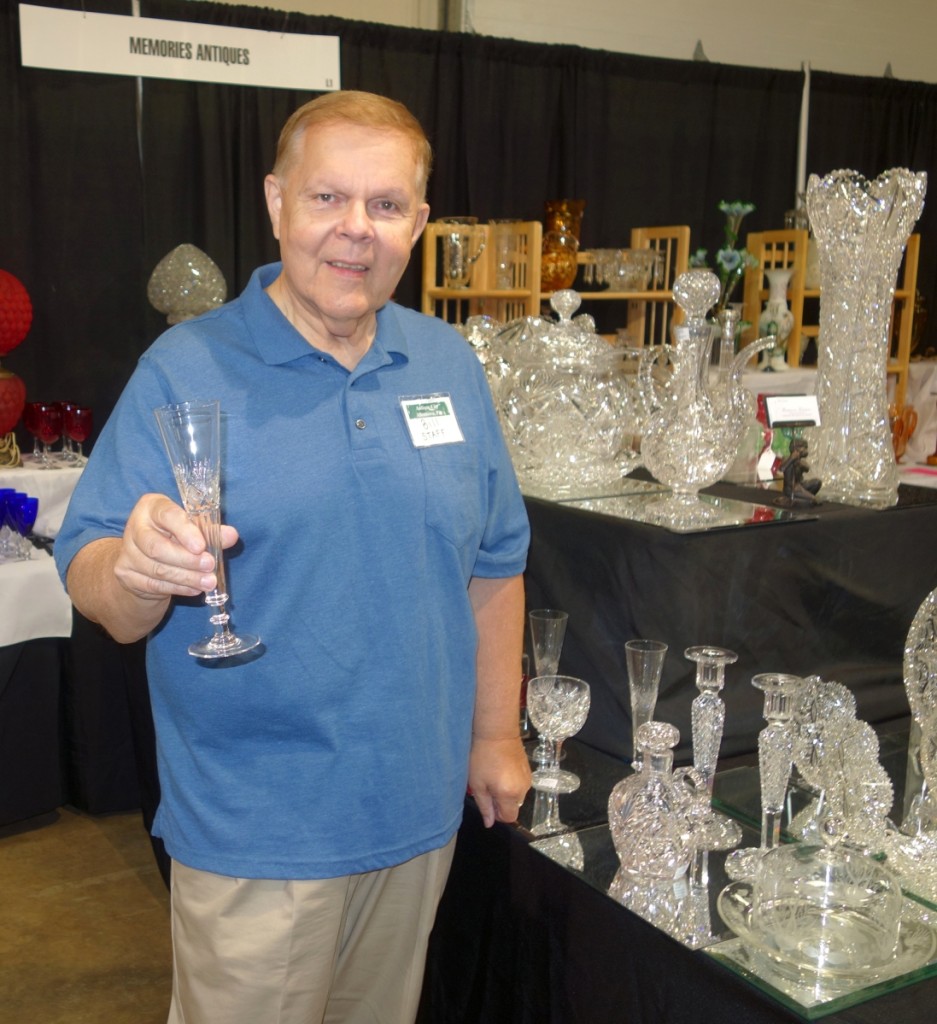 Bill Thomas, manager of the show, shows his strong interest in early glass as he takes time out for a photo.