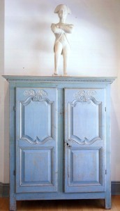 Found in Granville Ferry, New Brunswick, the Nineteenth Century carved and painted figure of Napoleon tops a Quebec armoire of circa 1760–75. The Louis XV case piece was discovered in a shed in Montreal, its carved features and original paint intact under a later coating of brown.