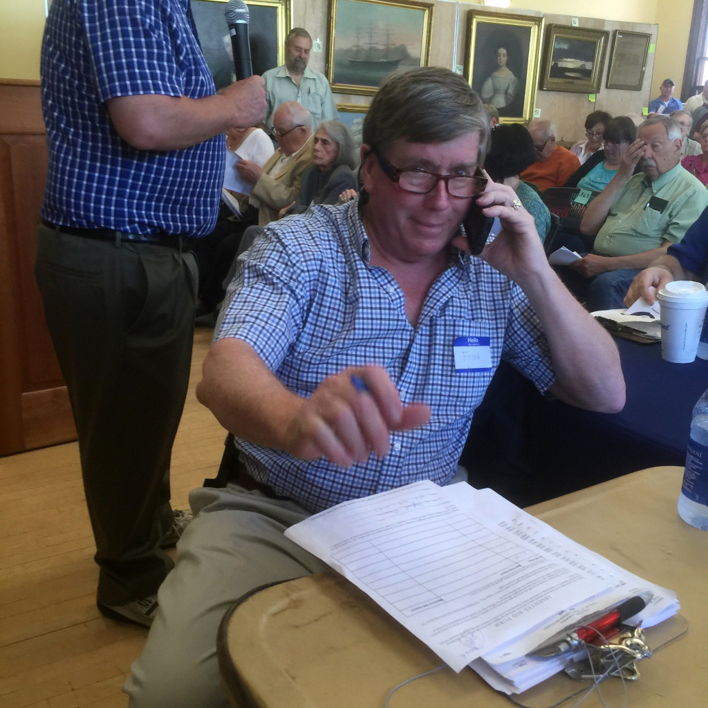 Company partner Frank McNamee, who also runs the Marion Antiques Center, mans the phones during his sale.