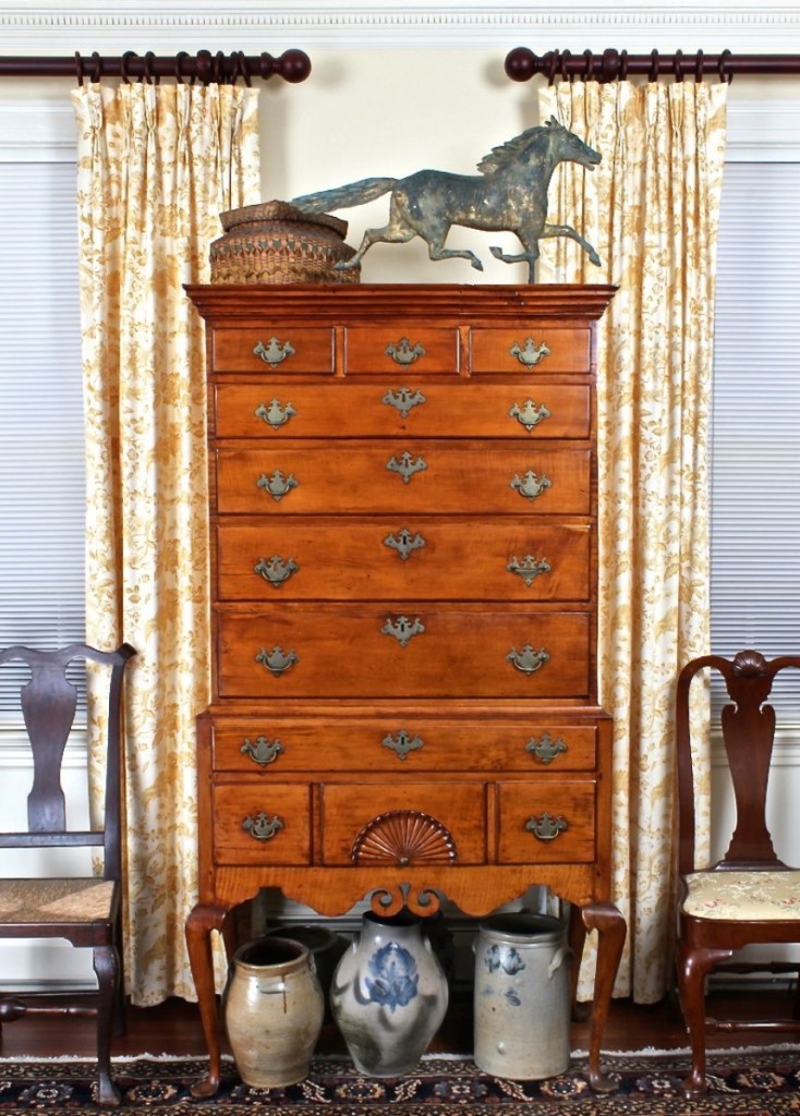 A focal point of the living room was the late Eighteenth Century Dunlap school maple high chest of drawers from New Hampshire, paired here with a molded copper Smuggler running horse weathervane, stoneware and one of many baskets for sale.