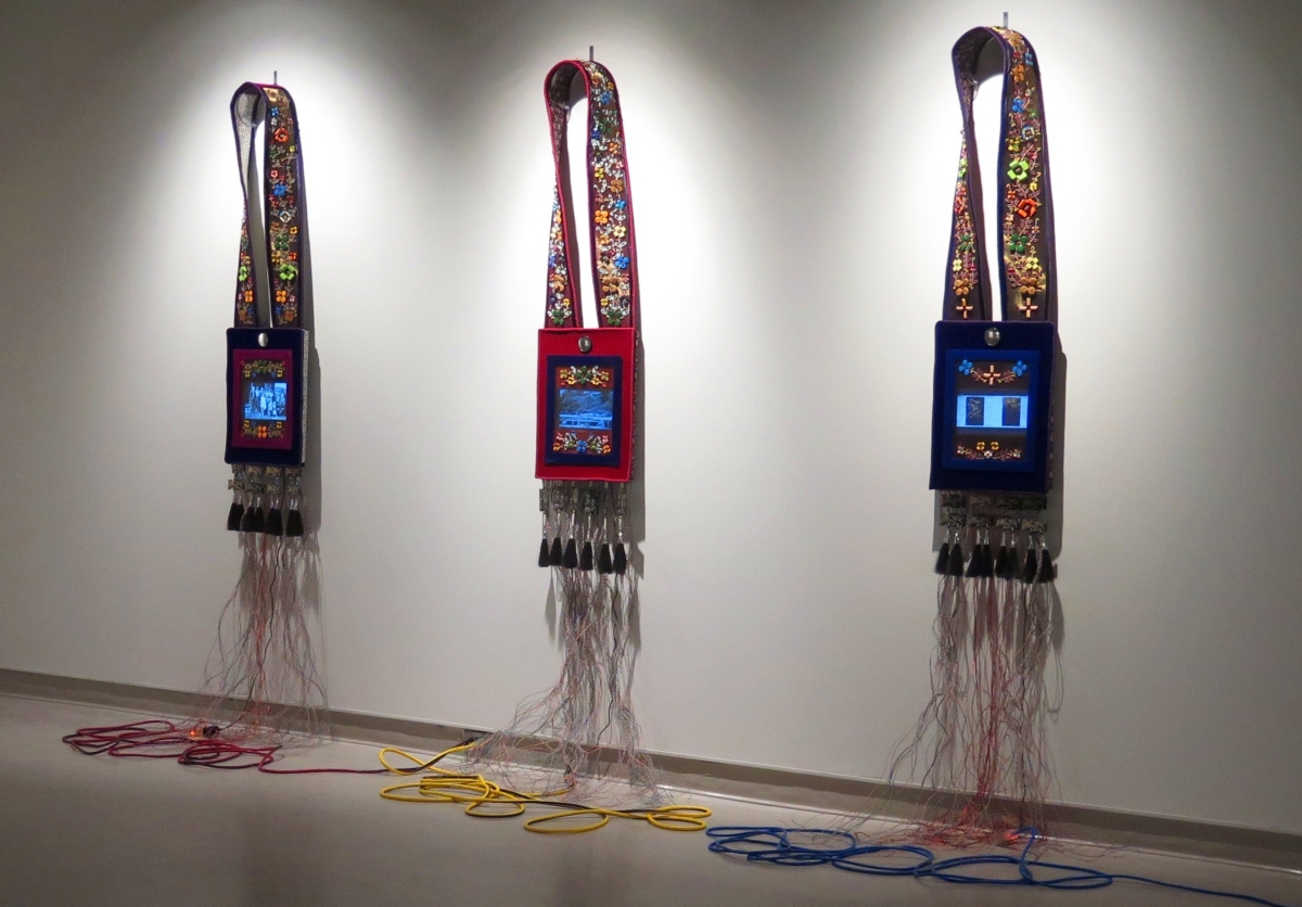 Trinity suite of bandoliers installation by Barry Ace (Anishinaabe [Odawa], b 1958), “Bandolier for Niibwa Ndanwendaagan (My Relatives)”; “Bandolier for Manidoo-minising (Manitoulin Island)”; “Bandolier for Charlie (In Memoriam),” 2011–2015; mixed media, 92-  by 14-15/16 by 3-  inches, collection of the artist.