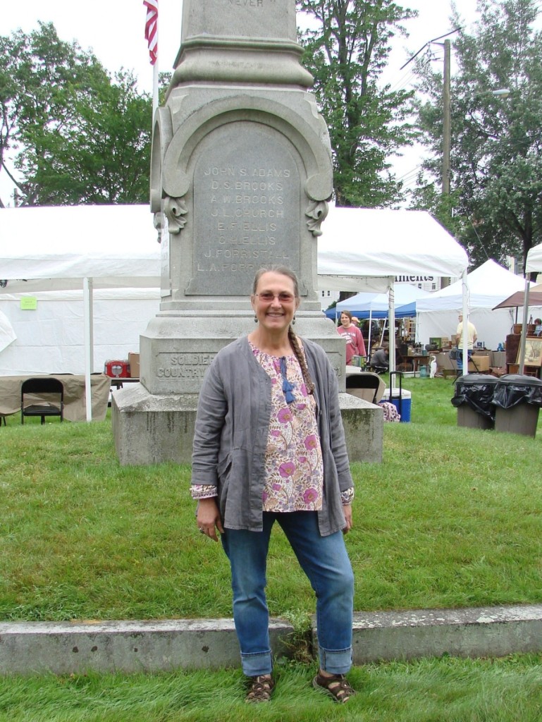 Kris Casucci, show manager, stands in front of the large Civil War monument, dedicated to local soldiers who died in that war.