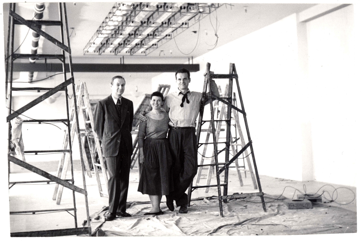 Alexander Girard with Ray and Charles Eames while setting up the “Good Design” exhibition at the Merchandise Mart Chicago, 1953. Vitra Design Museum, Alexander Girard Estate