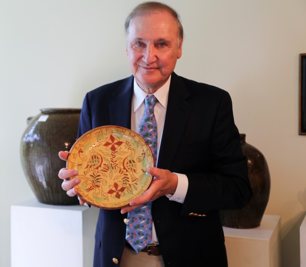 Auctioneer Tony Zipp stands with the second highest lot of the day, a Samuel Troxel redware sgraffito plate. The museum-quality piece fetched $82,600 as it crossed the block as the first lot of the day. It joins an example in the Winterthur collection as the only other known work from the maker with an inscription on the backside. It also has a link to the Troxel example in the Philadelphia Museum of Art, as both are dated and were made on the same day.