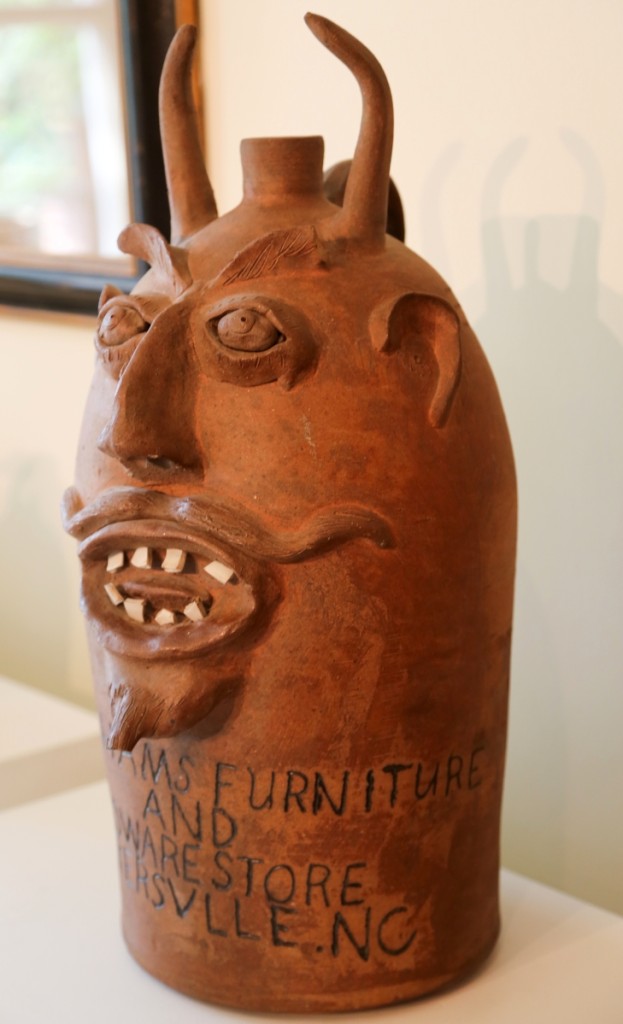 Davis P. Brown’s devil face jug did not sit in the window at Graham’s Furniture and Hardware Store for long. According to Mrs Graham, the residents of Bakersville, N.C., were either offended or scared of it when it graced the front window for the store’s grand opening. It is now known as one of the greatest examples of Twentieth Century Southern pottery in existence. Florida collector Martin Kaye scooped it up at $59,000 for his collection, calling it an iconic work. The only other known Brown Pottery example with store advertising is in the collection of the Philadelphia Museum of Art.