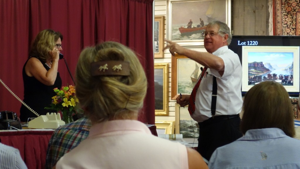 Every so often Jim Julia leaves the front of the auction hall and comes in closer contact with his staff managing the phones. Then he appears as if conducting the New York symphony.