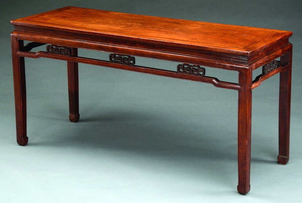 Selling within estimate for $33,880 was this huanghuali and hardwood, corner leg side table, China, Qing dynasty, with the provenance listing Janet and Richard B. Hobart Collection. The table measures 65½ inches long, 24 inches wide and 33 inches high.