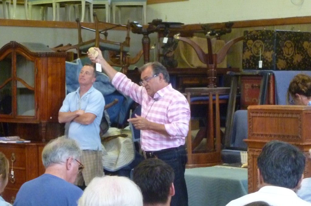 Rafael Osona holds up the Burdett tooth that was a “good value” at $252,000.