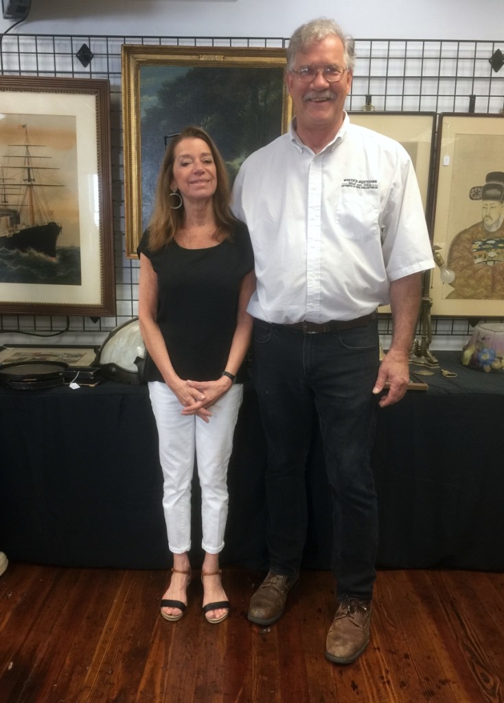Gallery owners Kathryn Black and John White take a moment before their auction to pose in their new headquarters.