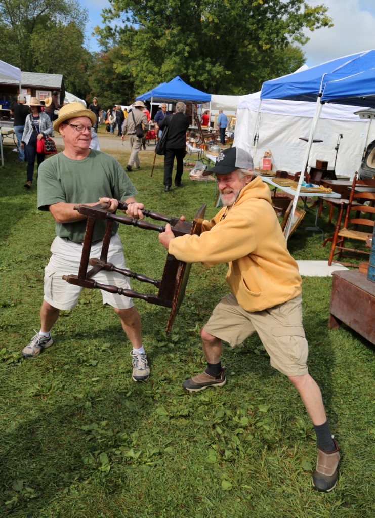 Derik Pulito and Don Heller battle it out over a Connecticut River Valley tavern table. Heller purchased the piece from Pulito, noting its special size and provenance to the Aaron brothers.         —May’s Antique Market