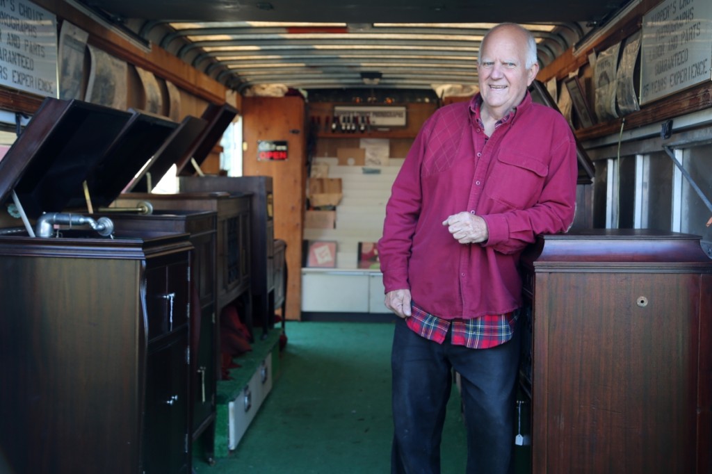 Ken Woodbury, Nipper’s Choice, Keene, N.H., rests his elbow on a selection of phonographs that the dealer holds in his annex trailer.                       —J&J At Brimfield Auction Acres