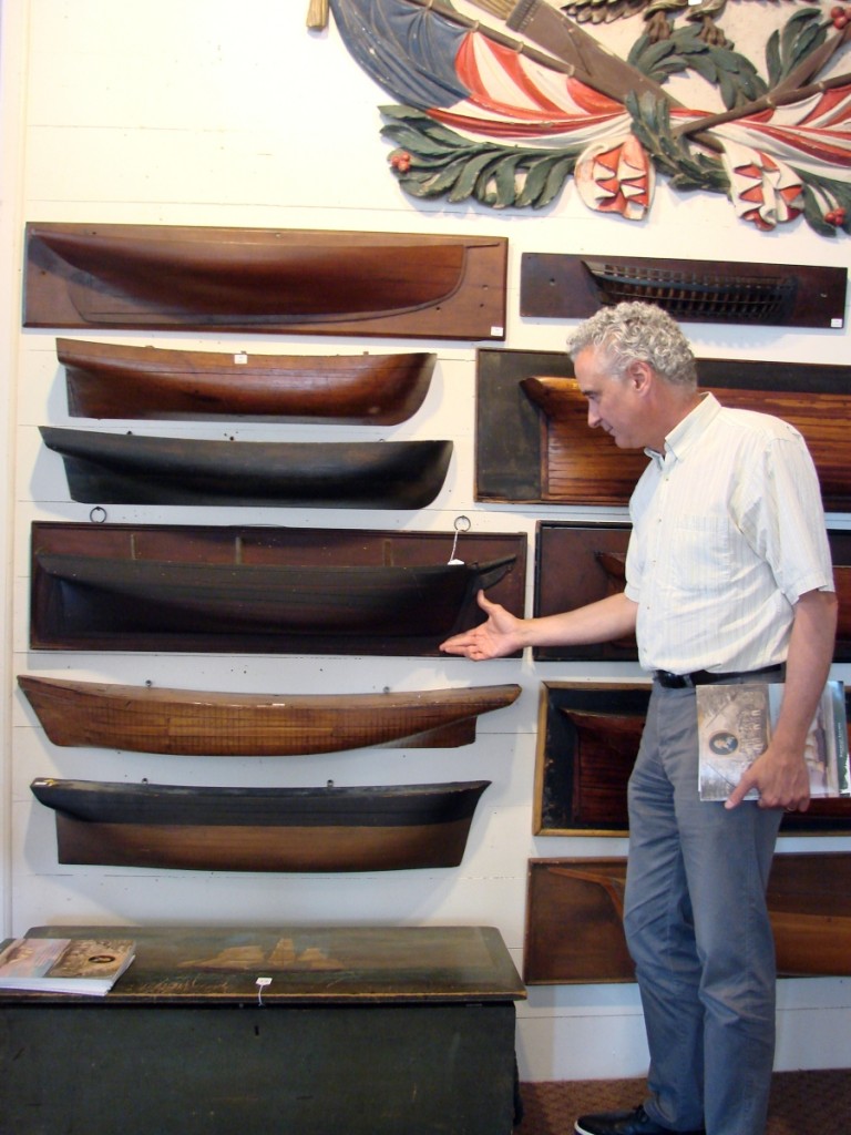 Curator of maritime art and history at the Peabody Essex Museum Dan Finamore examines some of the half-hull ship models.