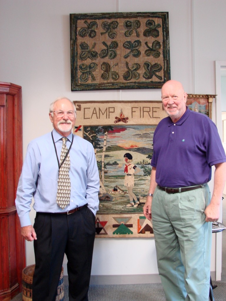 Jim Alexander and Steve Fletcher are shown with Pam Alexander’s favorite piece in the sale.