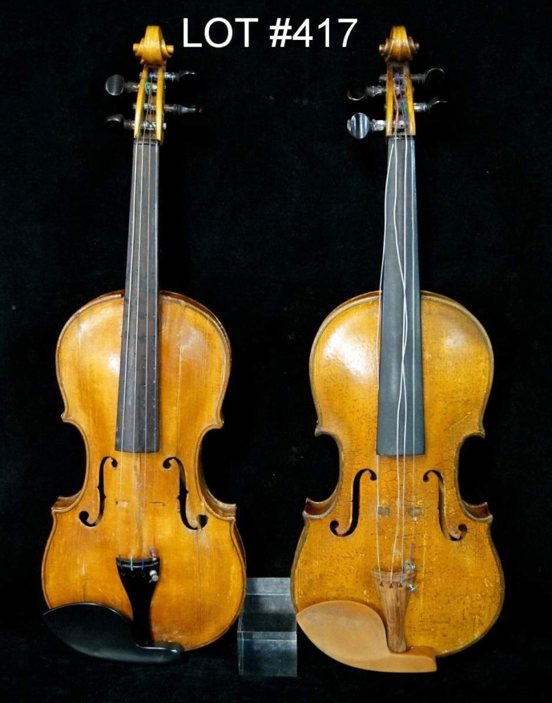 Lot 417 was a lot of two violins, one of which is rather unique with the back covered in pyrographic decoration and housed in a double case with a purple lining.