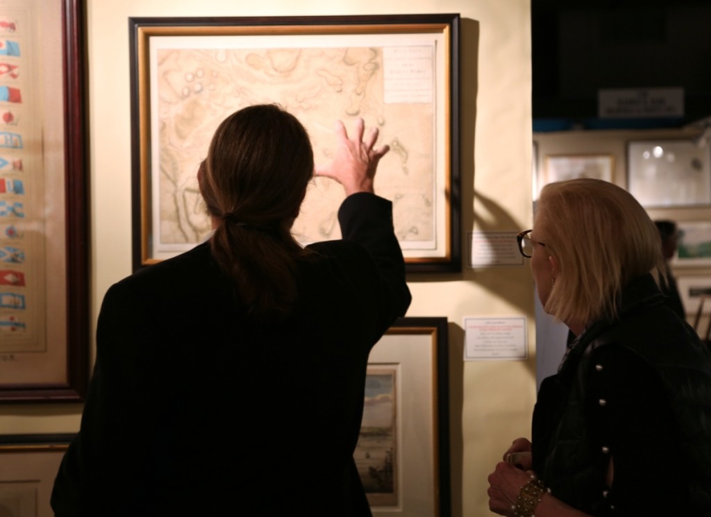 A man and woman examine an early Boston map at Arader Galleries, Philadelphia.