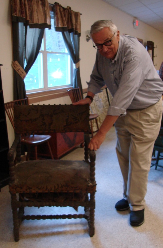 Ron Bourgeault with an early English Jacobean turned armchair with turkeywork upholstery. The chair had not been cleaned and Bourgeault said, “This is an example of furniture in the black.” It seemed cheap, finishing at $115.