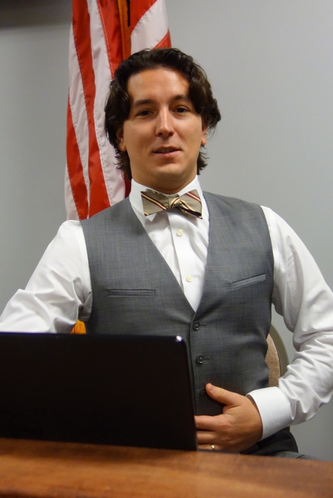 Michael Bertoia wears many hats during the auction, serving as auctioneer, fixing the computers, and taking phone bids.