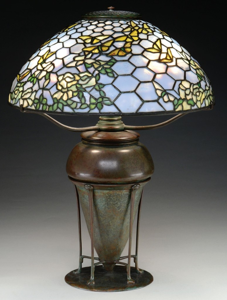 In a three-way tie for the highest priced lot, this signed Tiffany Studios boldly colored Nasturtium pattern chandelier, just under 29 inches in diameter, with mottled yellow and amber flowers and large mottled green leaves, finished at $84,700.