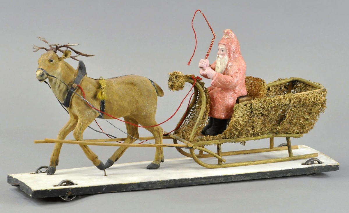 Lots of interest was shown in this Santa and Reindeer pull toy, very good to excellent condition, that went for $3,900, well exceeding the $800 high estimate. The composition reindeer with metal antlers is pulling the wood and loofah sleigh with a composition Santa at the reins. Measuring 17 inches long, all is mounted on a metal wheeled wooden platform.