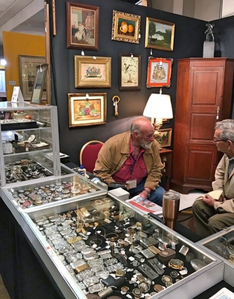 Marc Witus, Gladstone, N.J., left, talks with a customer.