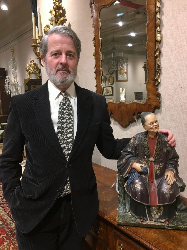 Peter Lang, Doyle senior vice president and director, English and continental furniture and decorative arts, with one of the Chinese nodding head figures.