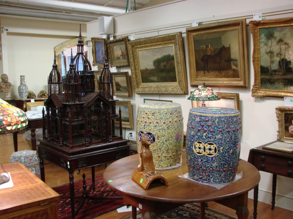 A portion of the material on display during the preview, including the mahogany birdcage and some of the paintings.