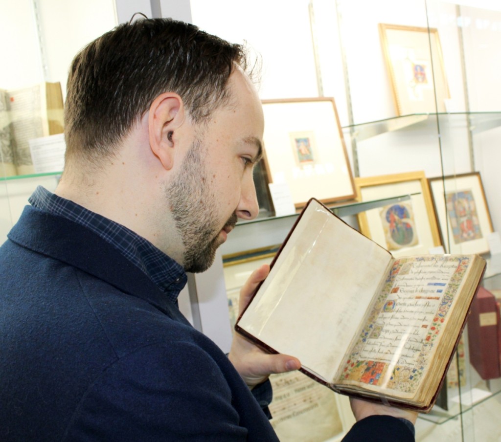 Matt Westerby, archivist and specialist at Les Enluminures, examines an illuminated manuscript comprising a collection of medical recipes and health regimens for the king and court, circa 1515–25. It was bound in a contemporary red velvet binding over wooden boards.