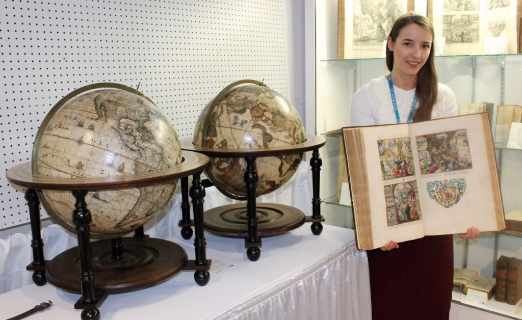 Nancy de Bruin shows a rare illustrated book at Antiquariaat de Roo, Zwijndrecht, Holland.