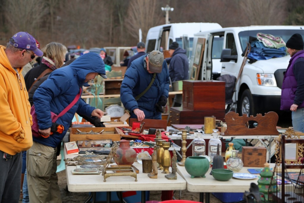 Buyers pick through the endless rows of tables at the market.